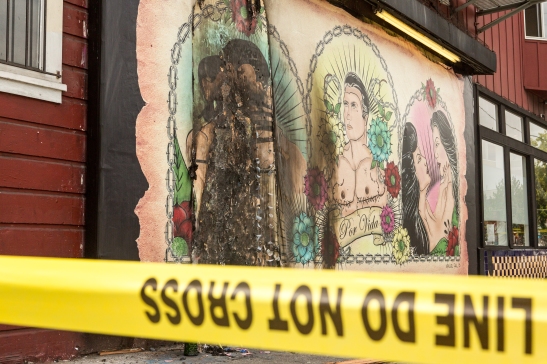 Yellow police tape surrounding the recently burnt LGBT mural Por Vida by Manuel Paul on Bryant St (Photo by Khaled Sayed/Bay News Rising)